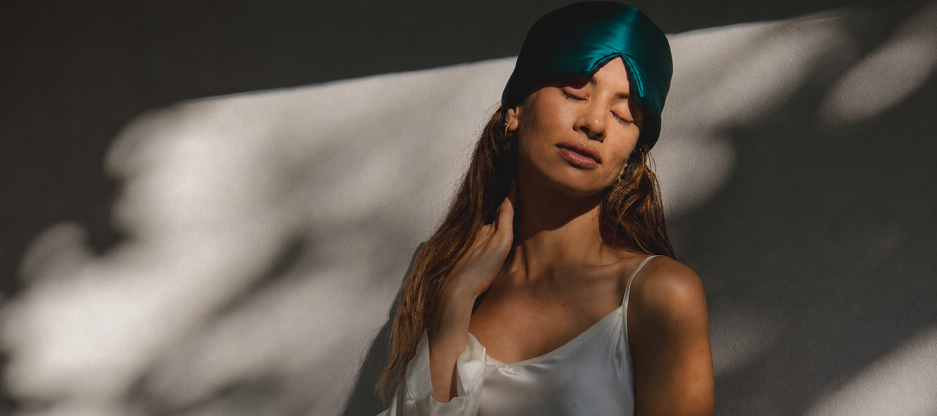 Woman enjoying the Green Premium Sleep Mask in soft sunlight